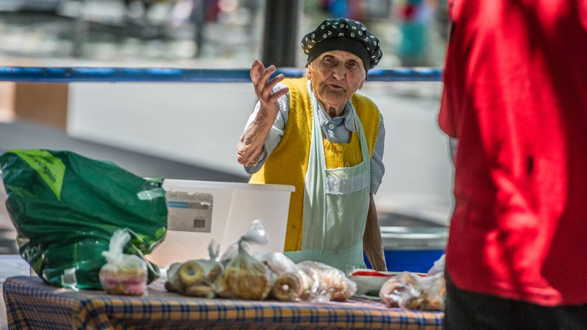 Stasia Dabrowski behind the tables of her soup kitchen in Garema Place on a Friday in 2016. Picture by Karleen Minney