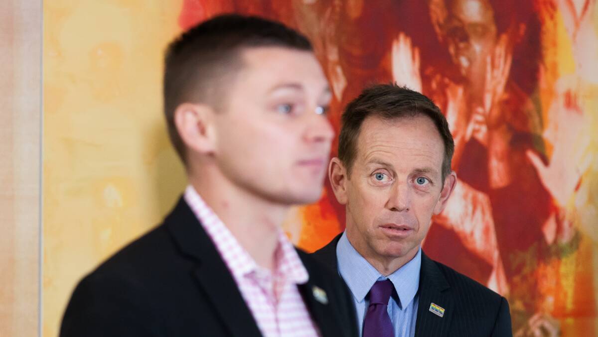 Greens leader Shane Rattenbury, right, looks on as Johnathan Davis speaks to journalists in 2020. Picture by Sitthixay Ditthavong