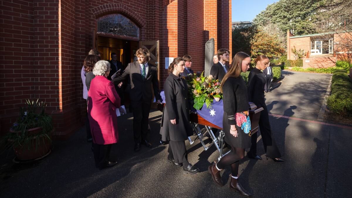Pallbearers carry Bill Wood's coffin from St Paul's Anglican Church at Manuka on Tuesday afternoon after a state funeral service. Picture by Sitthixay Ditthavong