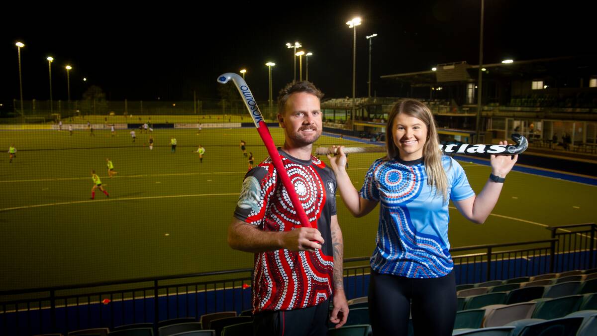 Garry Backhus and Emma Ronnfeldt in Indigenous jerseys for Hockey ACT's Reconciliation Round. Picture: Elesa Kurtz