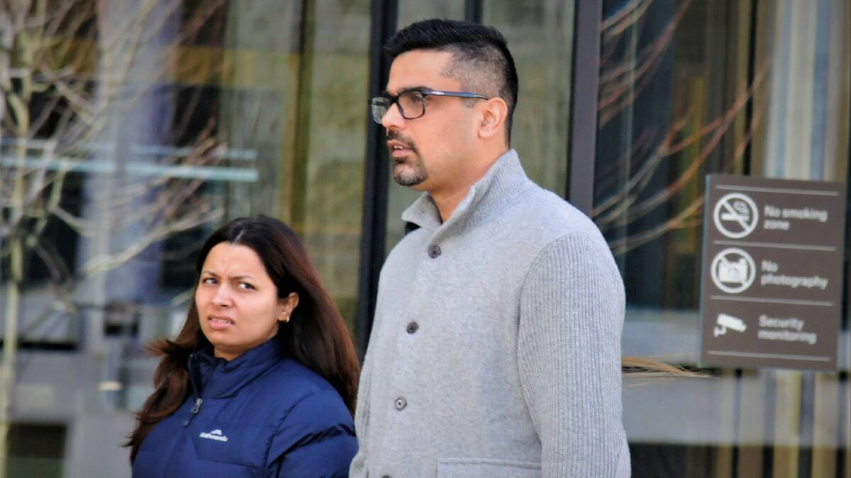 Karan Talwar, right, with a supporter outside court last year. Picture by Blake Foden