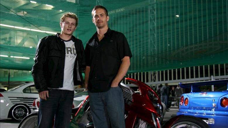 Former Fast & Furious stuntman Rhys Kember, left, with Paul Walker, a star of the movie franchise. Picture StarNow