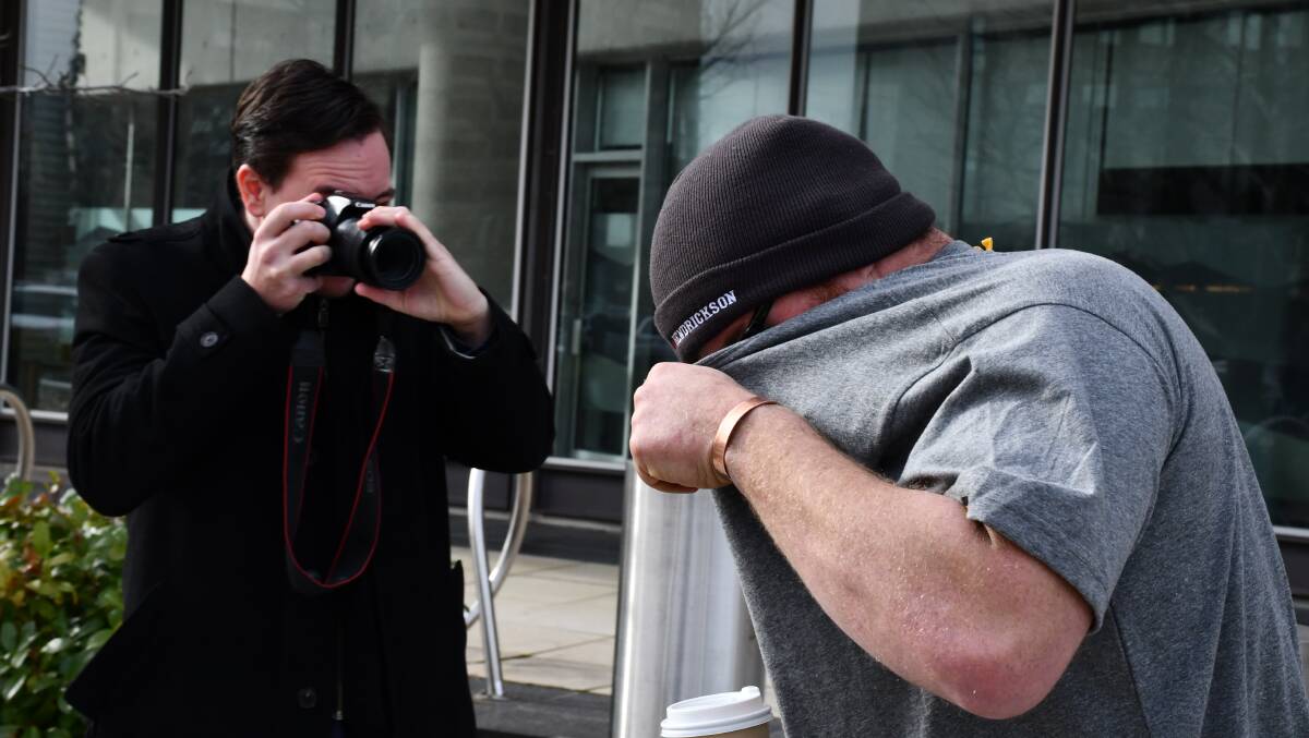 John Kirk, right, tries to hide from a reporter. Picture by Blake Foden