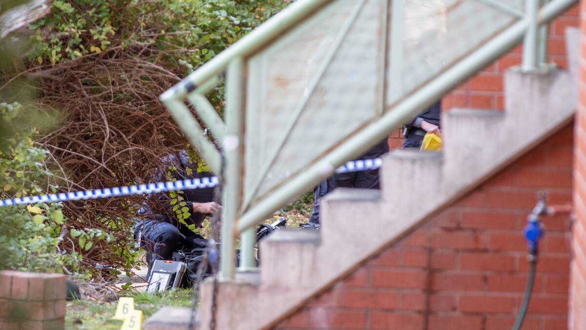 Police collect evidence after Glenn Walewicz was killed. Picture by Sitthixay Ditthavong
