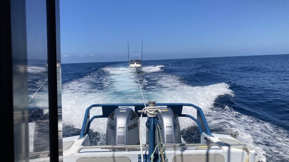 A fishing vessel is towed to shore after being struck in the engine by a marlin off the Far South Coast. Picture: Marine Rescue NSW