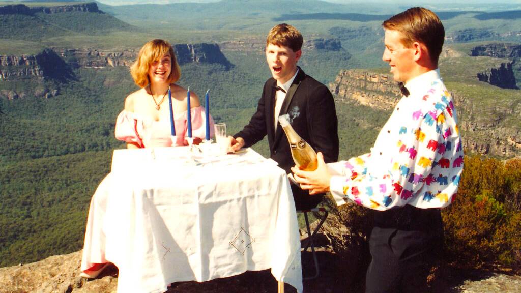 The moment Shane Rattenbury popped the champagne atop the Castle on April 18 1993, with Nicky Davies and Will Keogh looking on. Picture by Duncan McIntyre