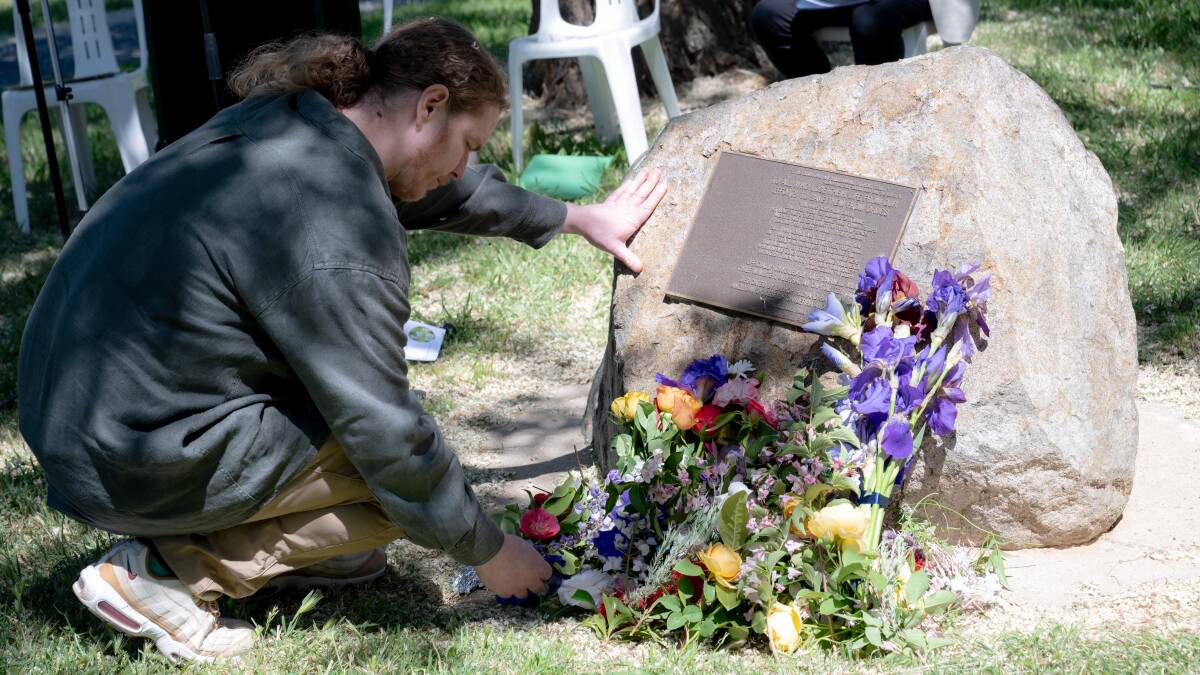 Canberra Alliance for Harm Minimisation and Advocacy executive director Chris Gough laying a flower at the memorial. Picture by Elesa Kurtz 