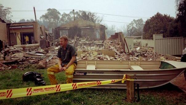 Matt Dutkiewicz at the scene of his house that was destroyed in the 2003 Canberra fires. Picture by Carol Dutkiewicz