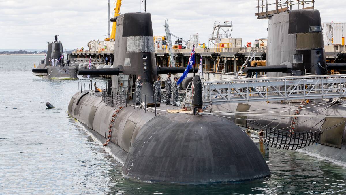 An Australian Collins class submarine docked in front of the UK nuclear-powered attack submarine, HMS Astute. Picture AAP