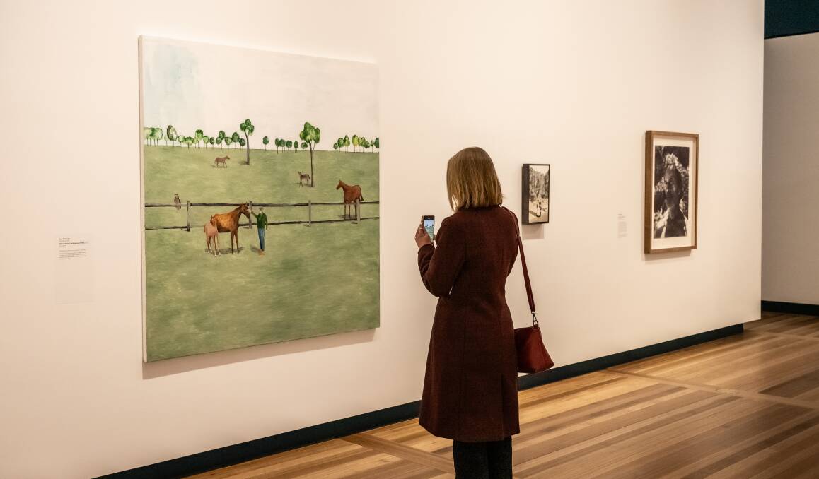 A gallery-goer checks out William Nuttall with horses in a field, Noel McKenna's Darling Portrait Prize winner. Picture by Karleen Minney