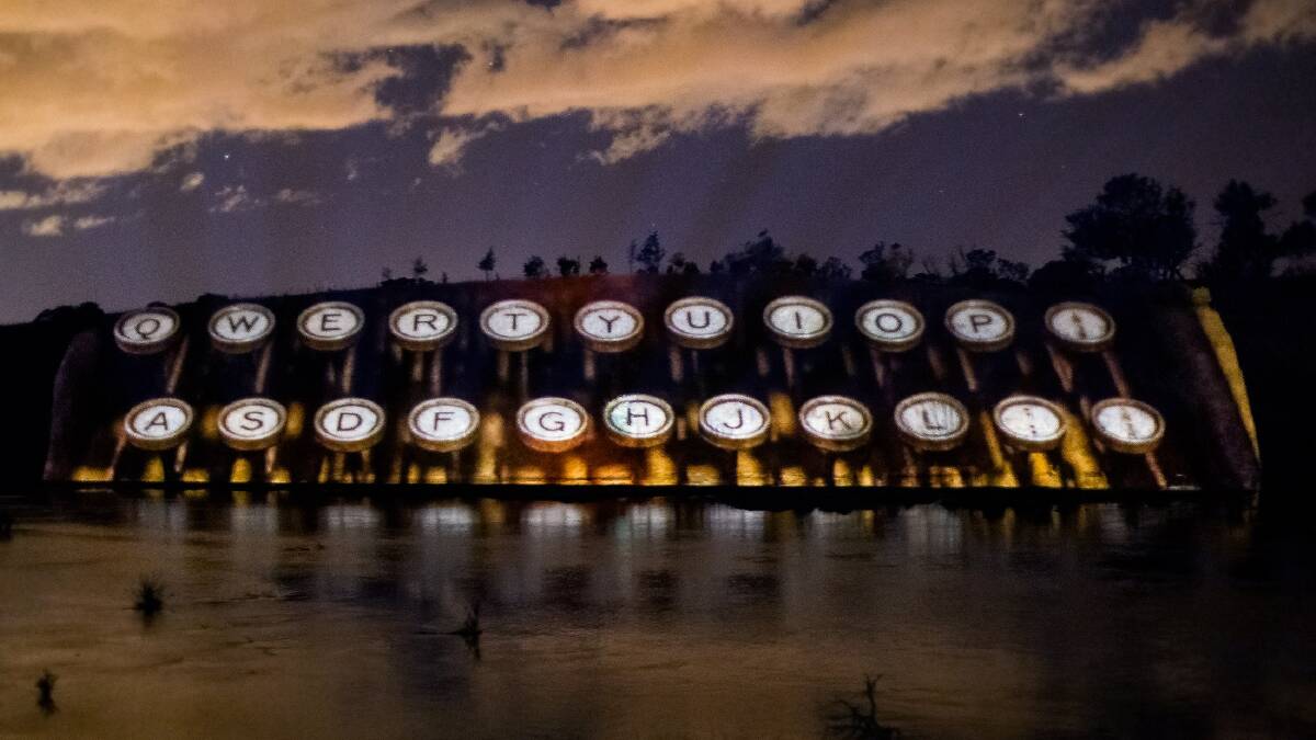 A photograph of poet/activist Mary Gilmore's typewriter is projected on the Murrumbidgee riverbank.