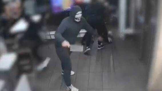 A CCTV still showing Jack Ford brandishing a cleaver at Hungry Jack's. Picture supplied