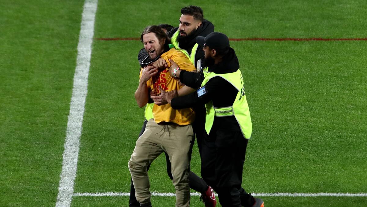 Former Raiders player Mark McLinden was tackled by security after invading the pitch on Sunday. Picture Getty Images