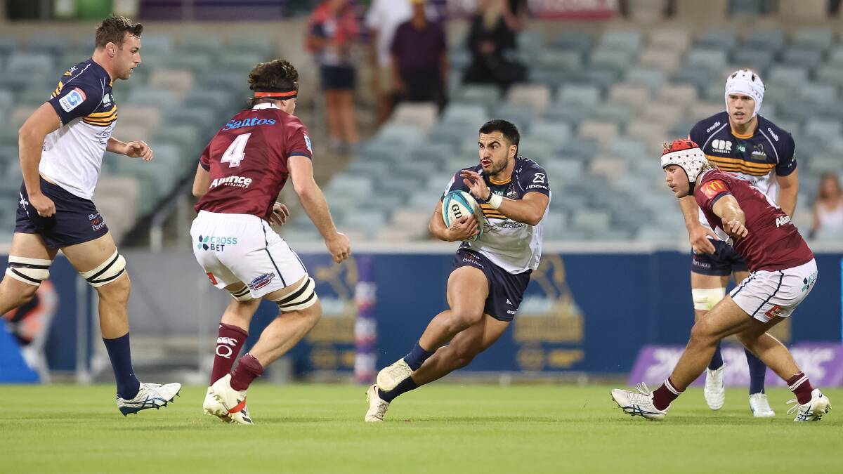 ACT Brumbies fullback Tom Wright takes on the Queensland Reds defensive line on Saturday night. Picture by Sitthixay Ditthavong