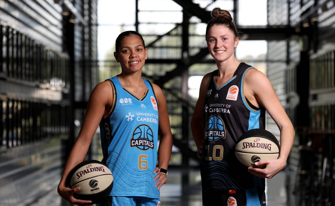 Shaneice Swain (left) and Gemma Potter show off the Capitals new Indigenous inspired uniforms. Picture by James Croucher