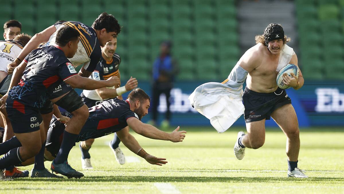 A topless Lachlan Lonergan charges down the field in Sunday's victory. Picture Getty Images