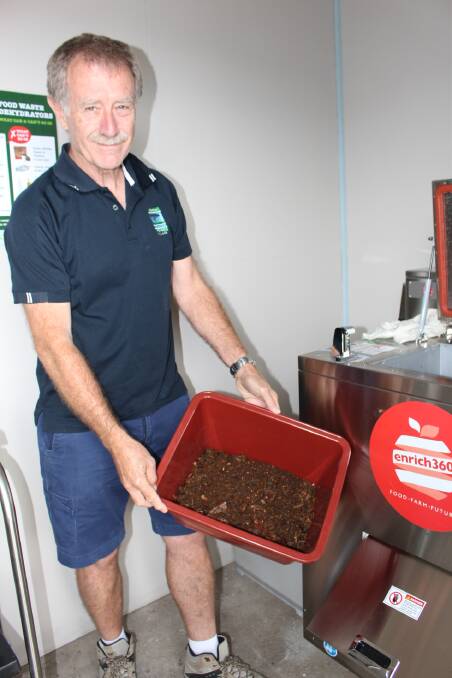 David Lee at Acacia Ponds puts in three buckets of waste to get half a bucket of dehydrated waste out.