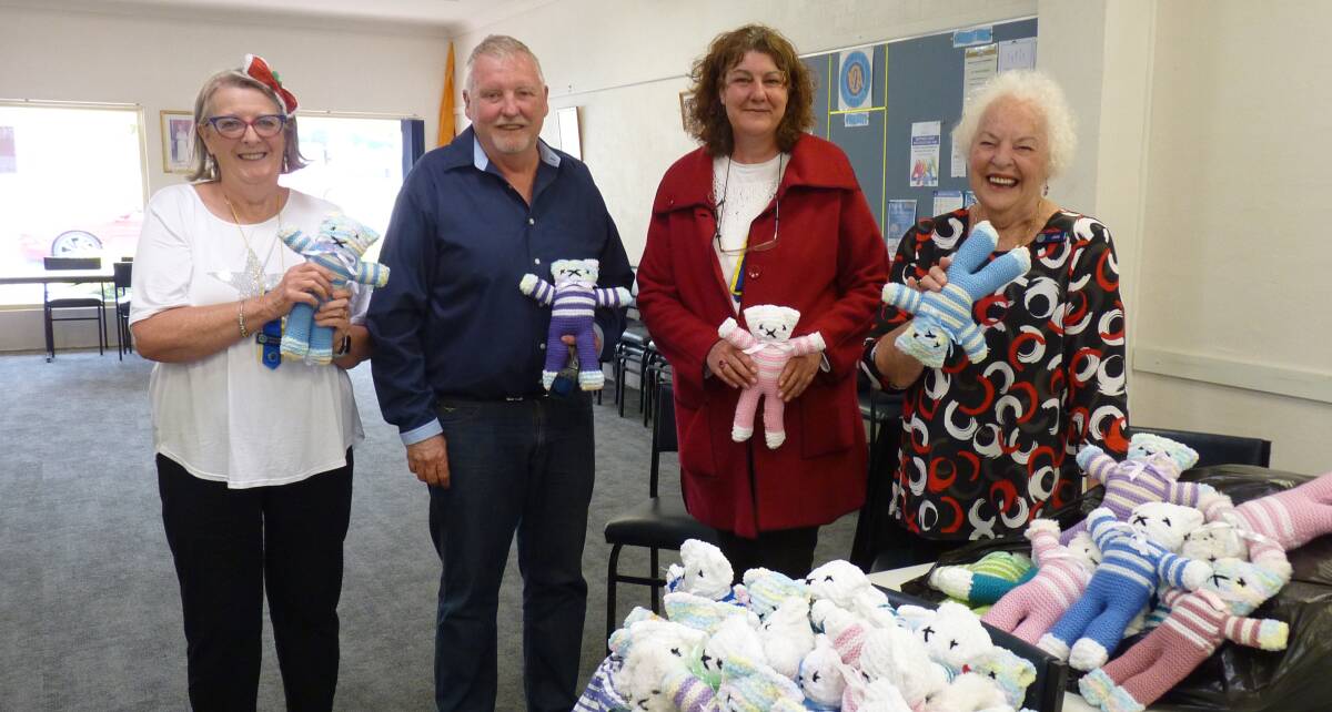 Garry, a paramedic with the branch members accepting the donation of comfort bears that were donated to the local ambulance service. Picture supplied 