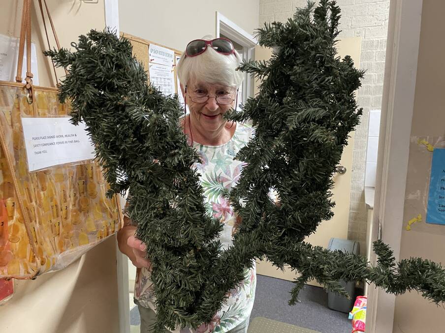 Alison Jenkins with two arms of a Christmas tree that arrived with a bag of donations and will go in the bin.