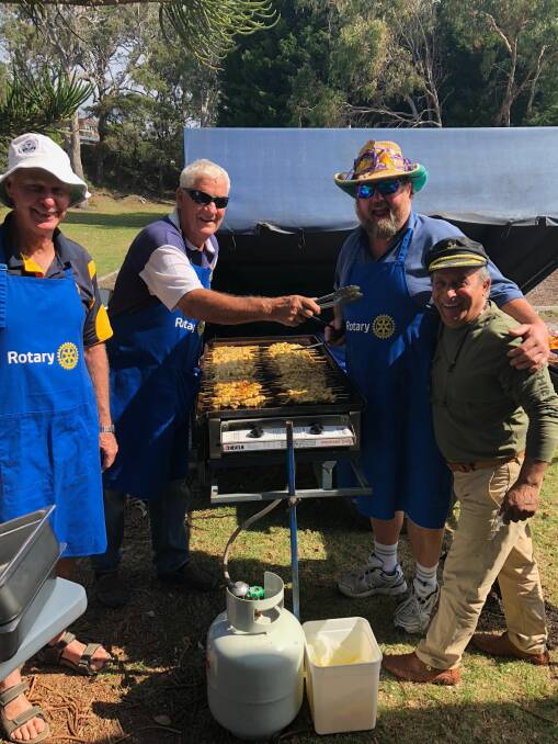 Daryl Dobson, second left, often seen manning the barbecue for Pambula Rotary.
