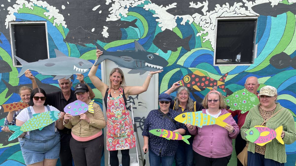 SueEllen Yates and Lynne Koerbin with disability clients. The painted walls will be home to fish painted by the group. Picture By Denise Dion