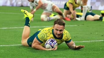 Wagga's Corey Toole scores a try in Australia's quarter-final win on Friday morning to help set up a shot at gold. Picture AAP