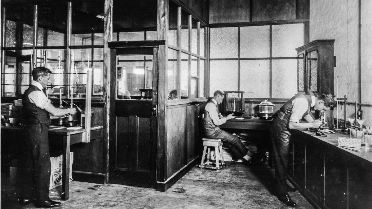 Cyril Callister, left, busy at work at the rudimentary Fred Walker laboratory in 1923. Picture courtesy of Kraft Foods Australia
