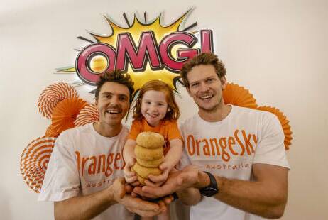  Orange Sky's Nic Marchesi and Lucas Patchett with doughnut lover Olive. Picture supplied