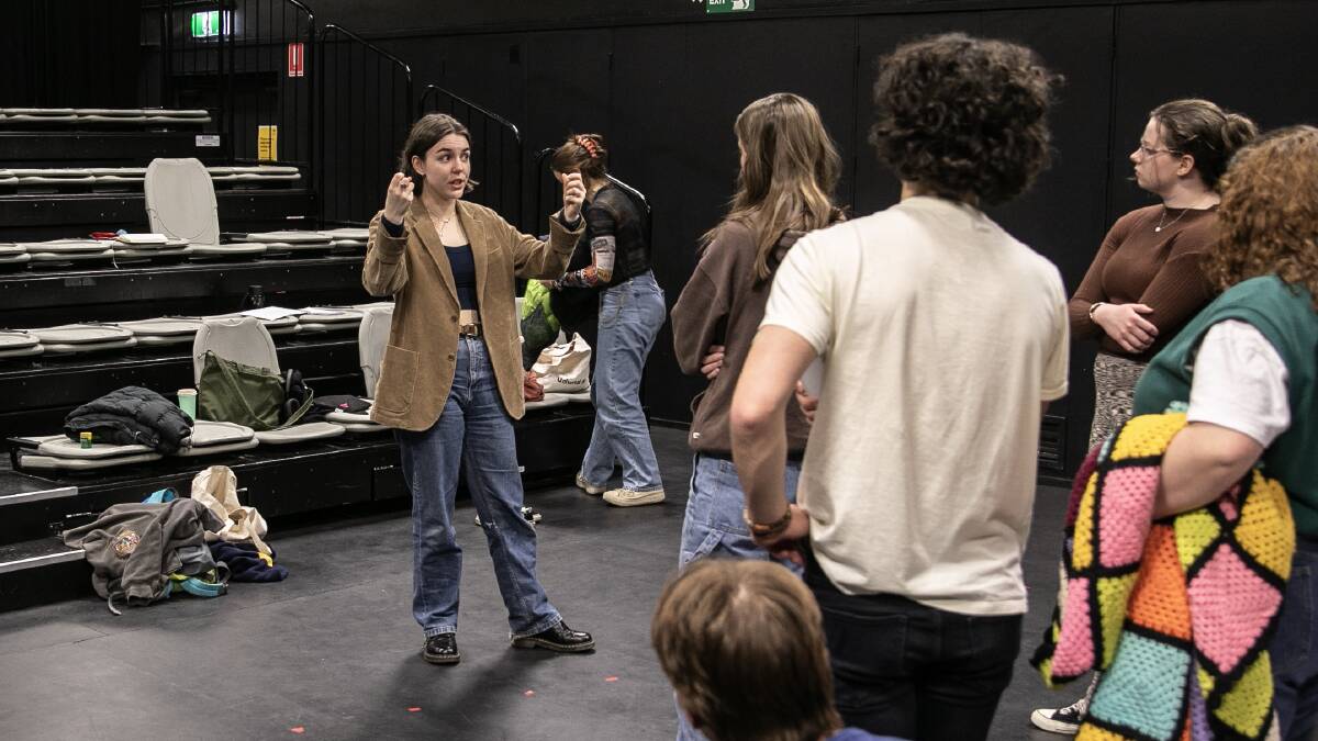 Director Catilin Baker, left, addresses her cast. Picture: Canberra Youth Theatre