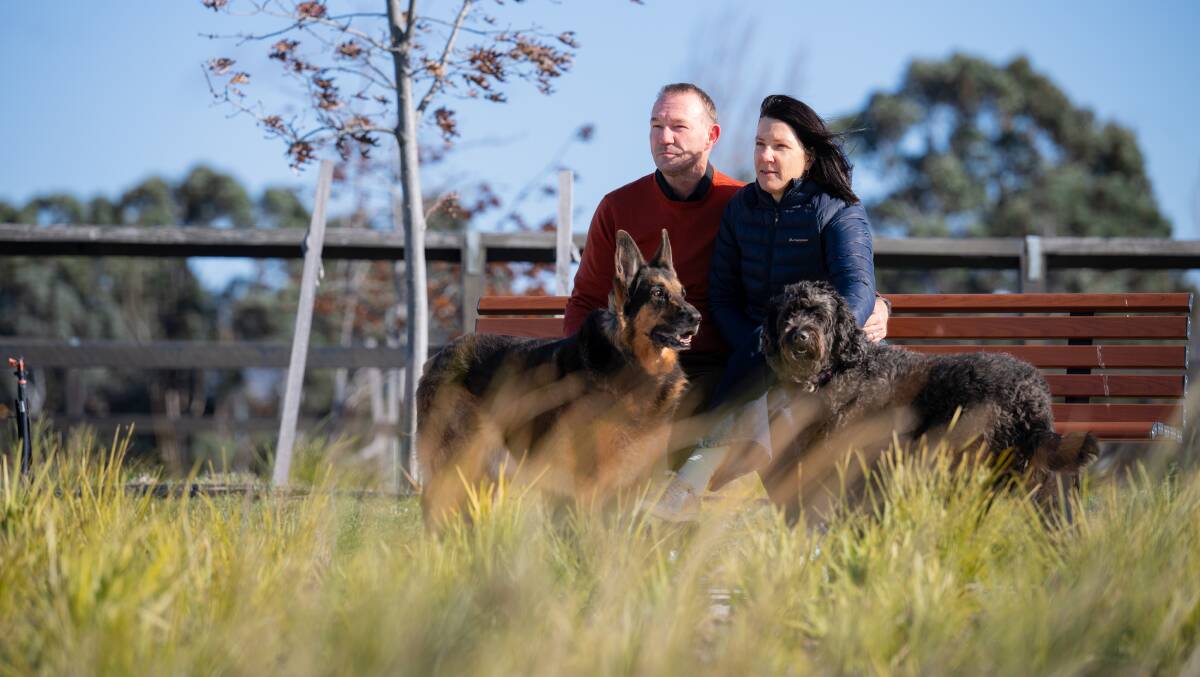 Sunday night marks the second anniversary of when Sarah Payne and Tom McLuckie's son, Matthew, was killed on Hindmarsh Drive by a drug-affected driver. They are pictured with Matthew's dogs Kaiser the German shepherd and Poppy the groodle. Picture by Sitthixay Ditthavong