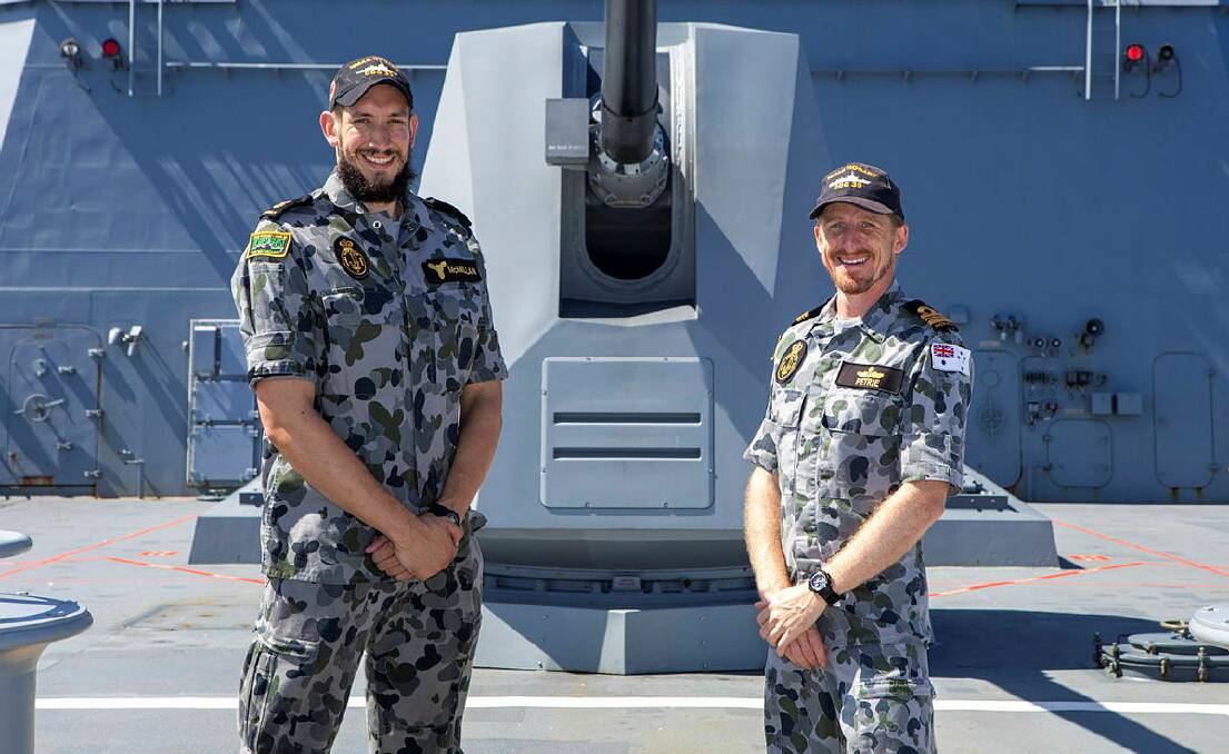 Leading Seaman Marine Technician Hugh McMillan and Lieutenant Commander Andrew Petrie on the forecastle of HMAS Hobart during the Exercise Rim of the Pacific off the coast of Hawaii.