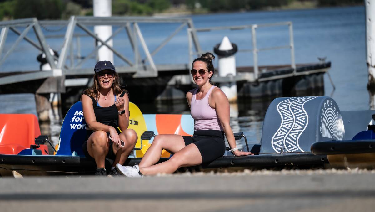 Sarah Bauer, of Watson, right, and Samara Vickers, of Hughes, check out the soon-to-be-defunct Lake Burley Griffin paddleboats. Picture by Karleen Minney