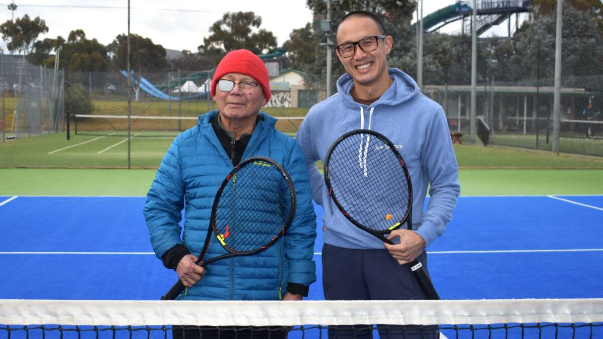 Stroke survivor Thiet Huynh hits the courts with the support of his caring family, pictured with son Kim Huynh. Picture by Xavier Huynh