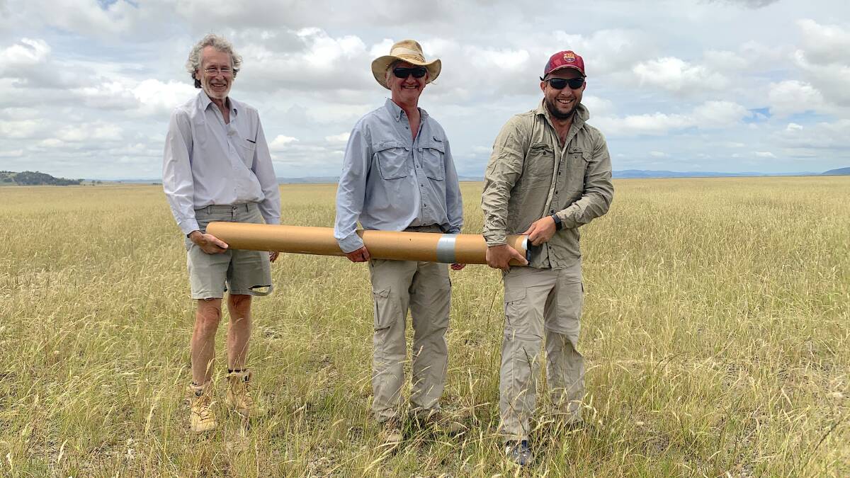 ANU scientists Brad Pillans, Bradley Opdyke and Chris Gouramanis lug a core sample across Lake George. Picture by Tim the Yowie Man