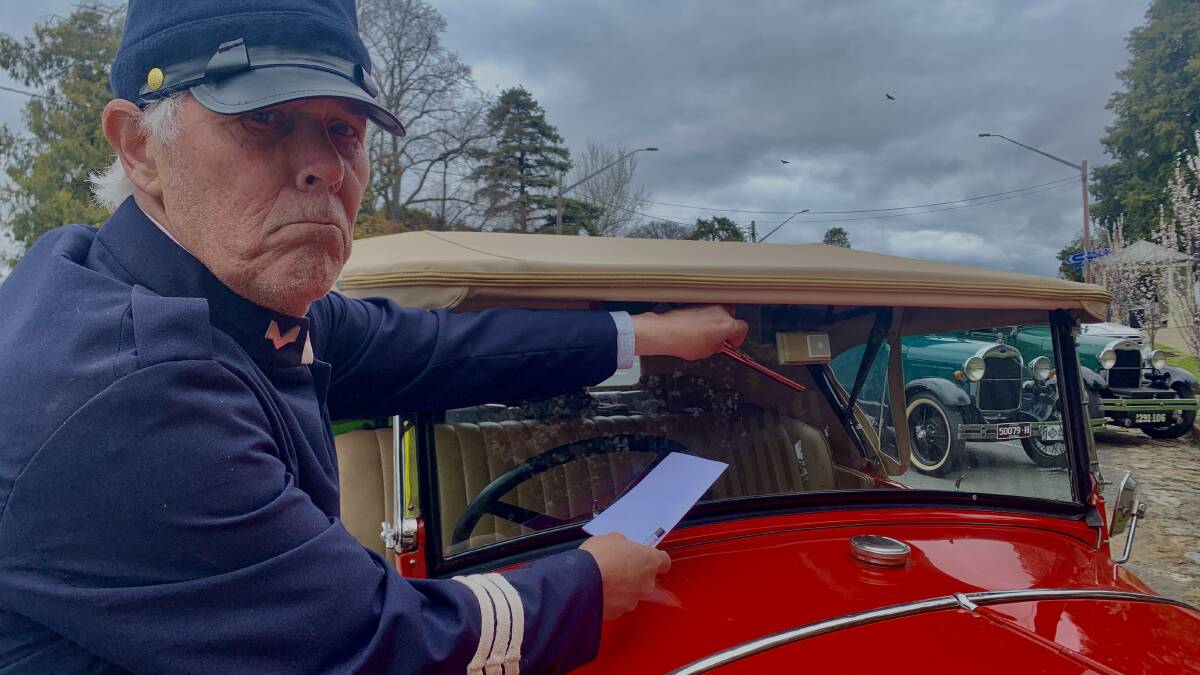 "Sergeant" John Stahel issues one of 200 infringement notices to Model A ford owners who descended on Braidwood as part of the club's national meet. Picture by Tim the Yowie Man