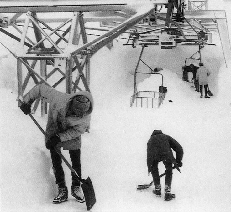 Digging out the chairlift after a 1964 blizzard. Skiers who cleared snow for two hours received a free day lift pass. Picture: Baglin/Perisher Historical Society