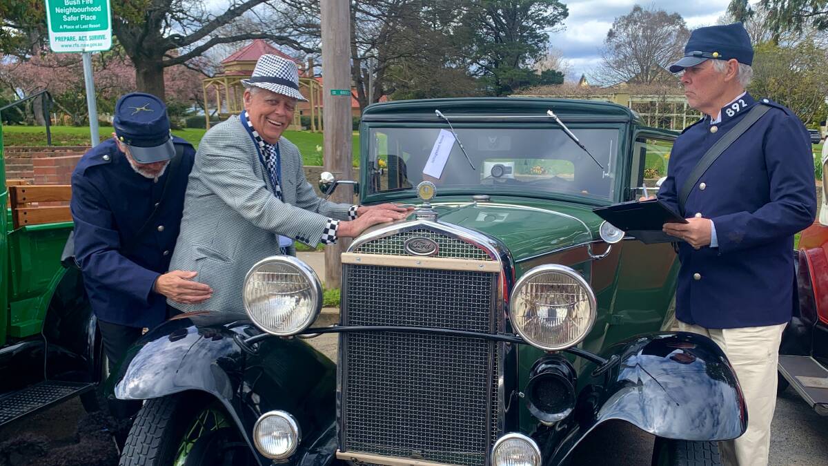 "Constable" Nick Fry frisks 1931 Model A Ford 'Victoria' owner Gilbert Haywood while "Sergeant" John Stahel issues him with an infringement notice. Picture: Tim the Yowie Man