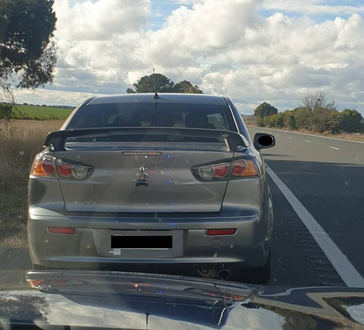 The silver Lancer stopped by police on the Federal Highway had four passengers. Picture supplied 