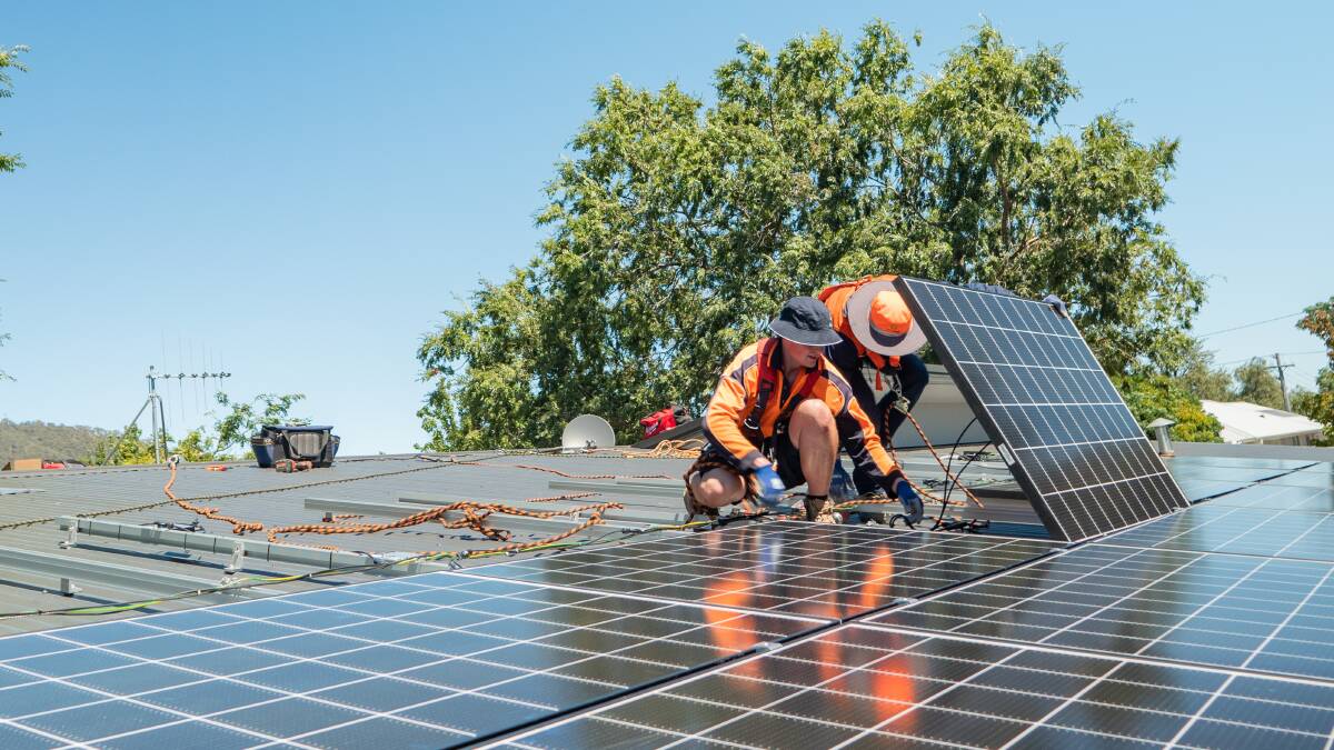 Solar installers working on a rooftop. Picture supplied