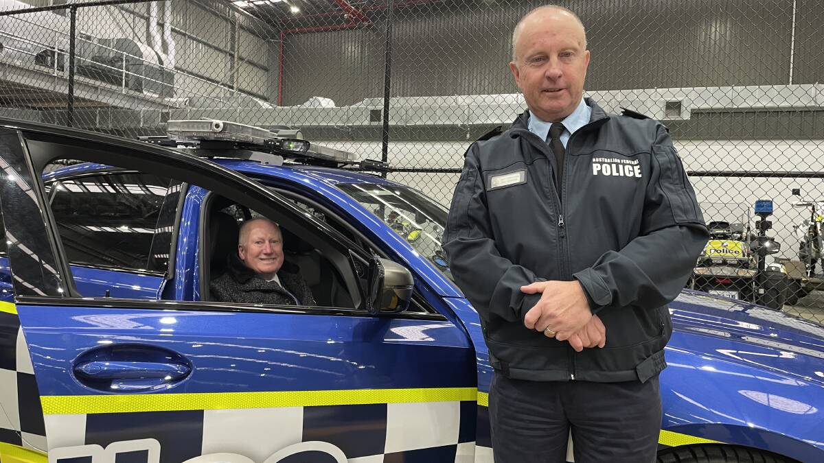 Police Minister Mick Gentleman and Chief Police Officer Neil Gaughan with the high-performance BMW M3 traffic operations car. Picture by Peter Brewer