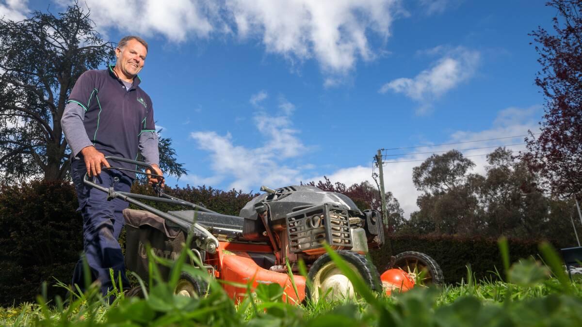 "Mowing wet grass is awful"; Jason Dillon on the mower, again. Picture by Sitthixay Ditthavong