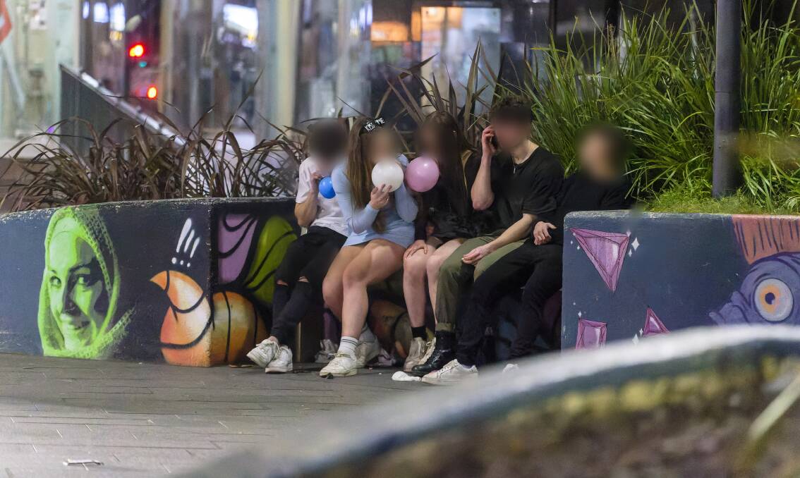 Teenagers openly inhaling nitrous oxide from balloons on Canberra's streets. Picture by Keegan Carroll