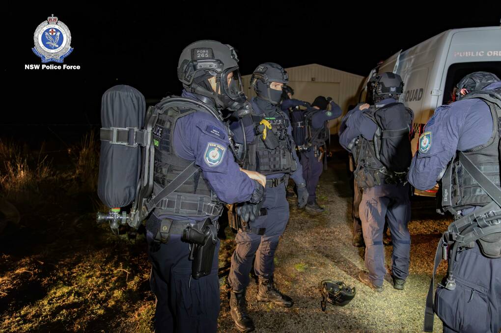 NSW tactical officers kit up during Operation Crear, a raid on a drug lag near Goulburn. Picture supplied 