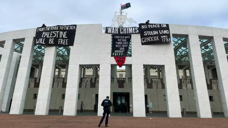 Four protesters managed to get on the roof of Parliament House. Picture by Brittney Levinson