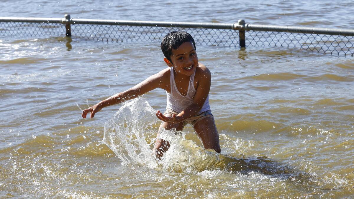 Evan Koirala, 4, escaped the heat by a cooling swim at Lake Burley Griffin. Picture by Keegan Carroll