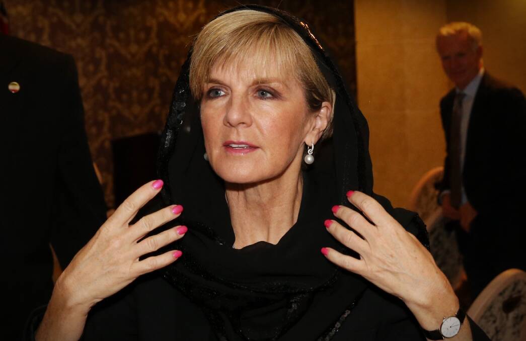 Julie Bishop replaces her head scarf after a press conference with the Australian media in Tehran in 2015. Picture: Andrew Meares