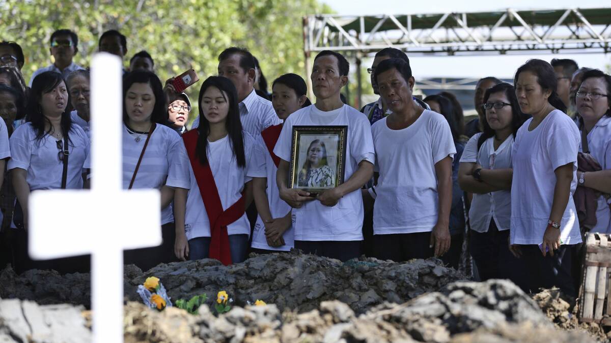 Mourners remember the victims of last year's church attacks in Surabaya. Picture: AP