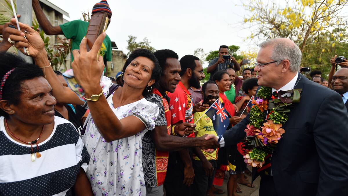 Scott Morrison meets locals in Port Moresby during the APEC in November 2018. It's time we placed a bit more emphasis on engagement with our region. Photo: AAP