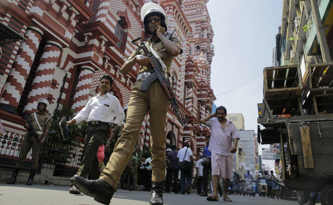 A Sri Lankan police officer patrols outside the same mosque last week in the wake of the Easter Sunday attacks. Photo: AP
