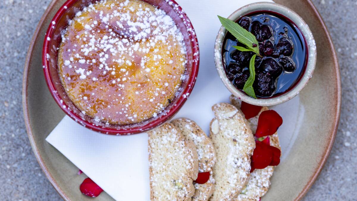White chocolate creme brulee with mixed berry compote and biscotti. Photo: Andrea Bryant